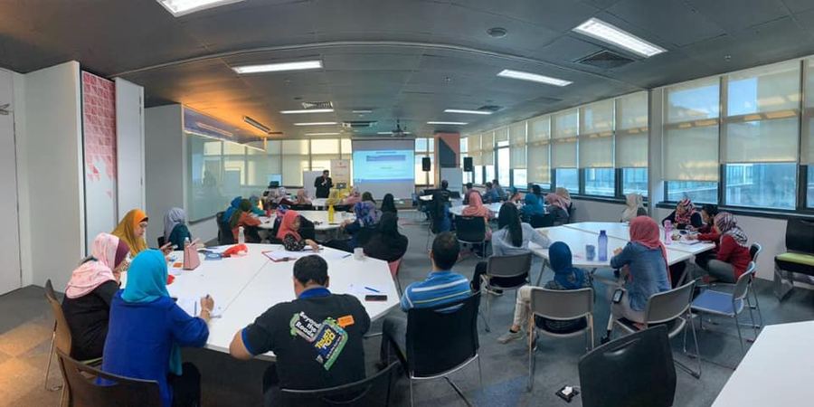 Participants working in small groups during a Kenny Lee training session